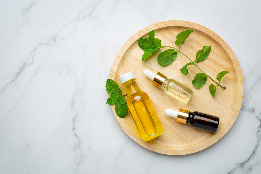 essential oils with natural ingredient arranged on a tray